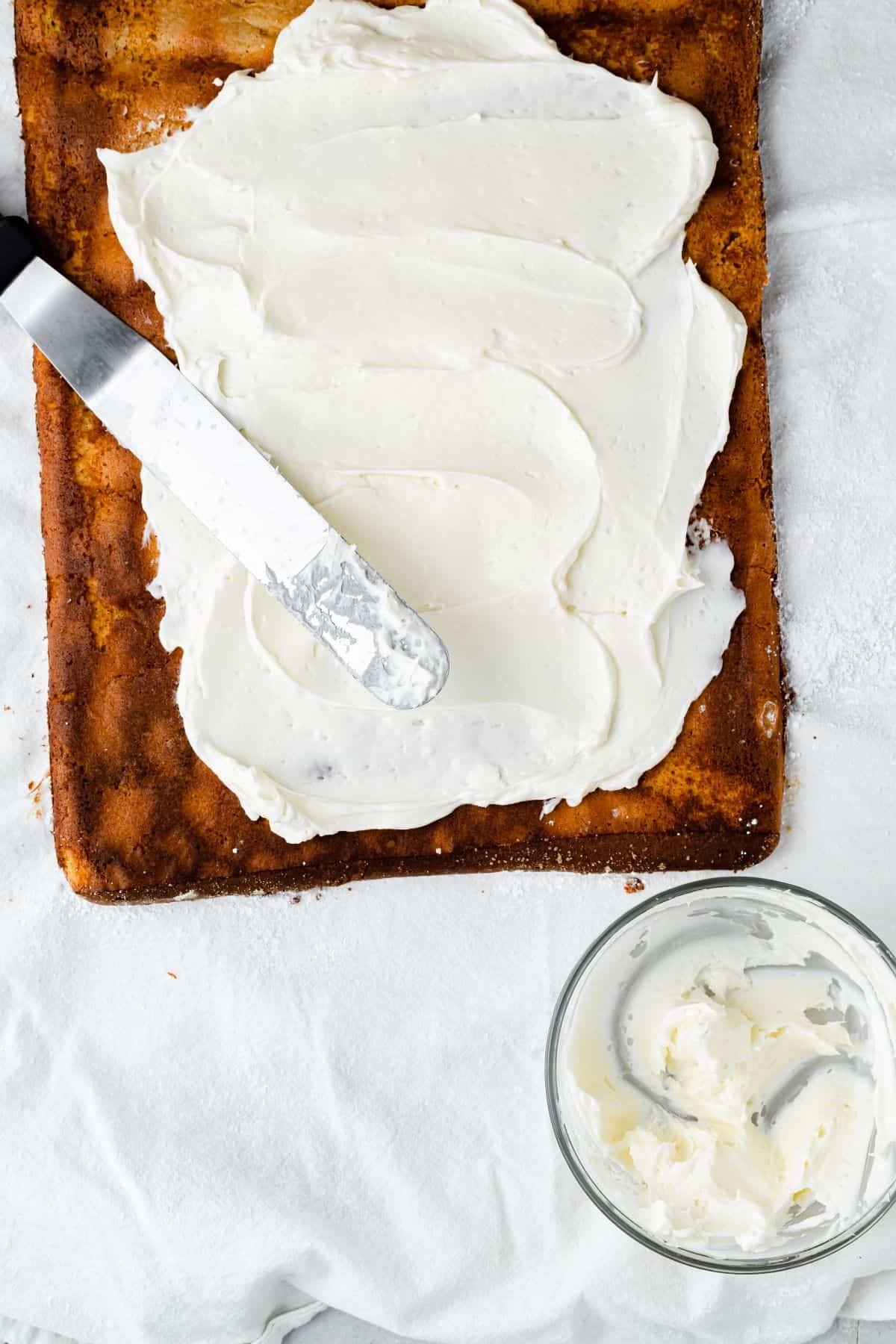 An unrolled pumpkin roll cake spread with filling