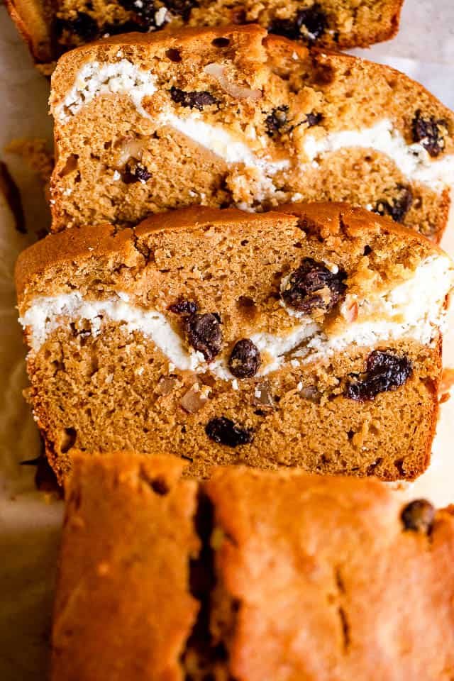overhead shot of pumpkin bread with a swirl of cream cheese and raisins