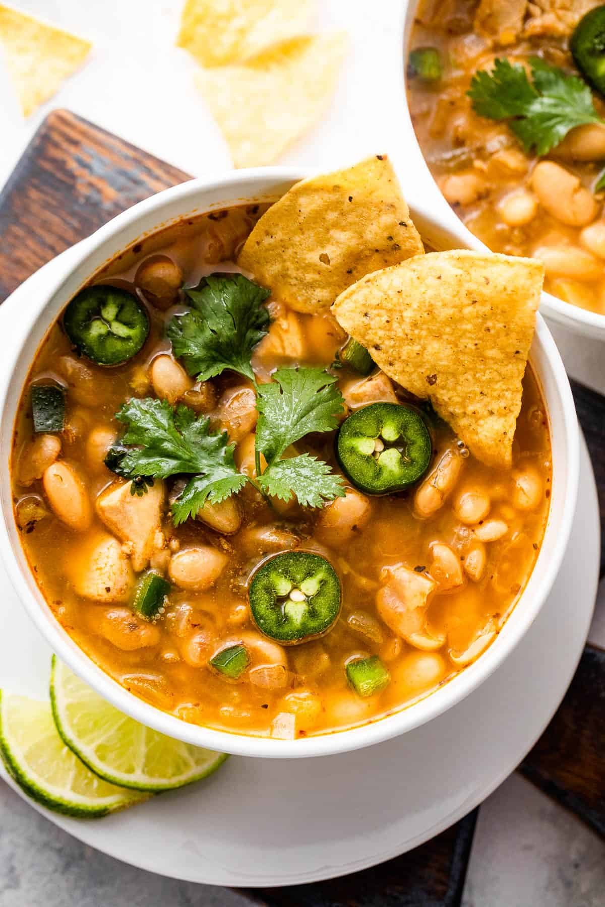 overhead shot of white soup bowls with chicken chili