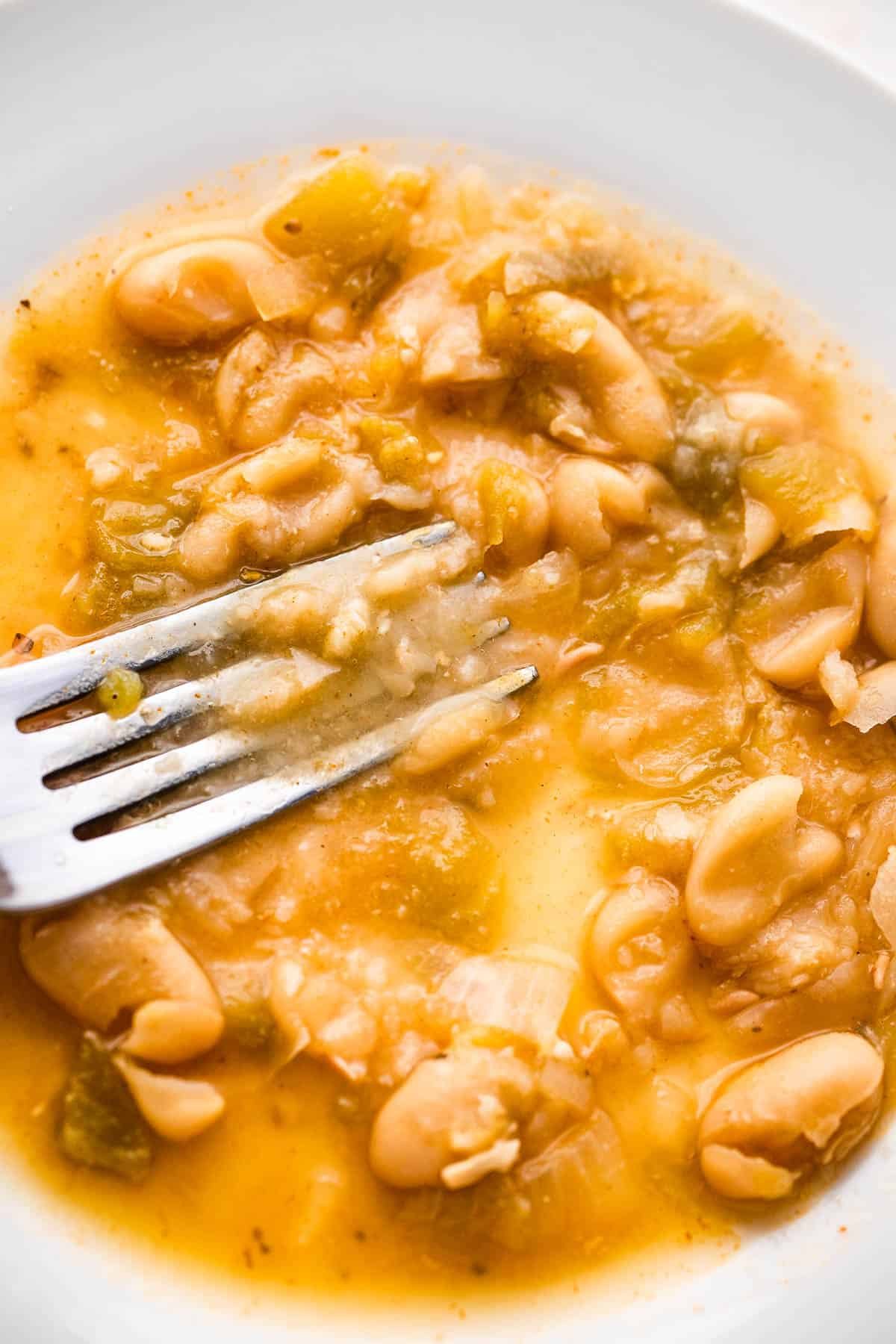 mashing beans with the back of a fork