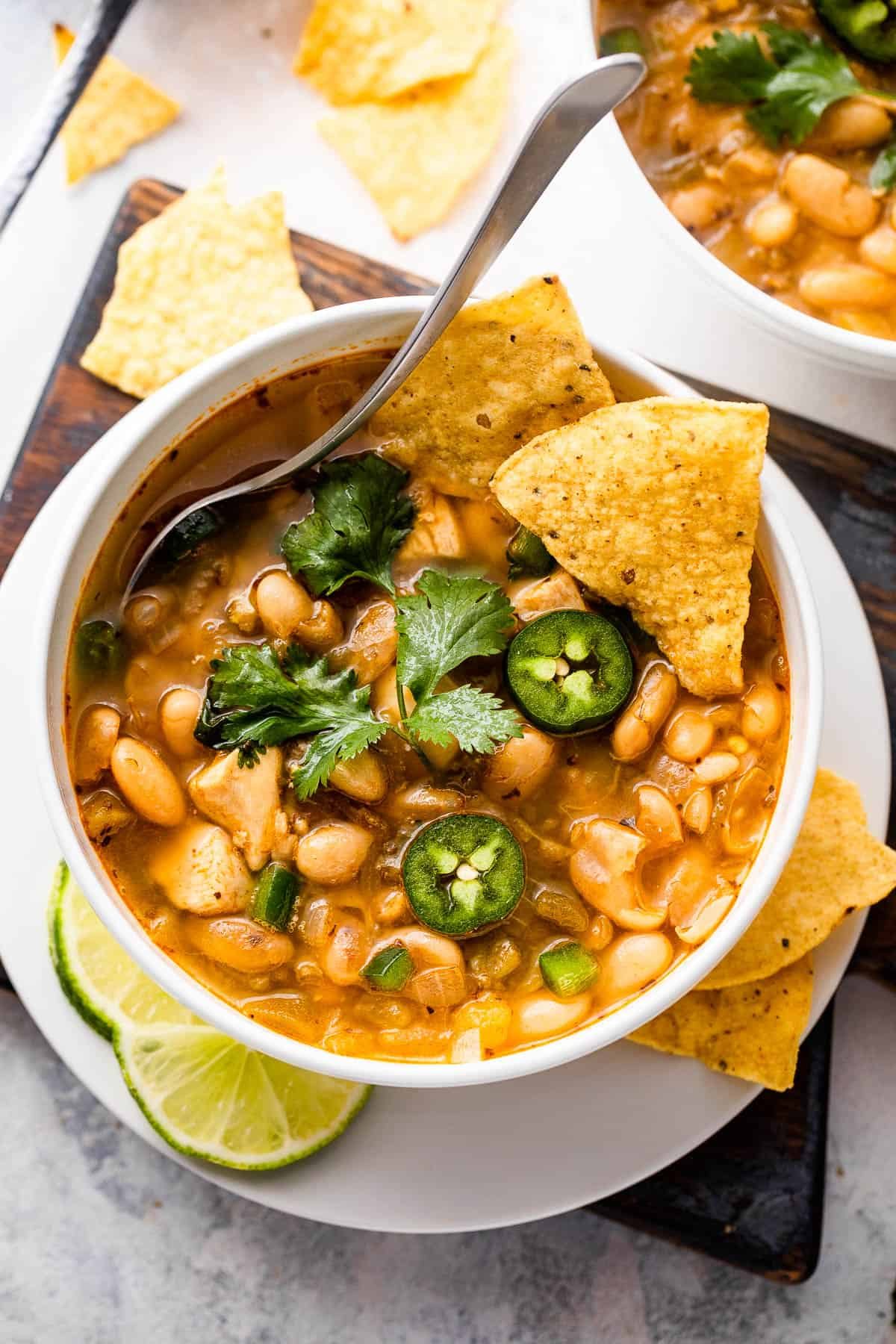 overhead shot of white soup bowls with chicken chili
