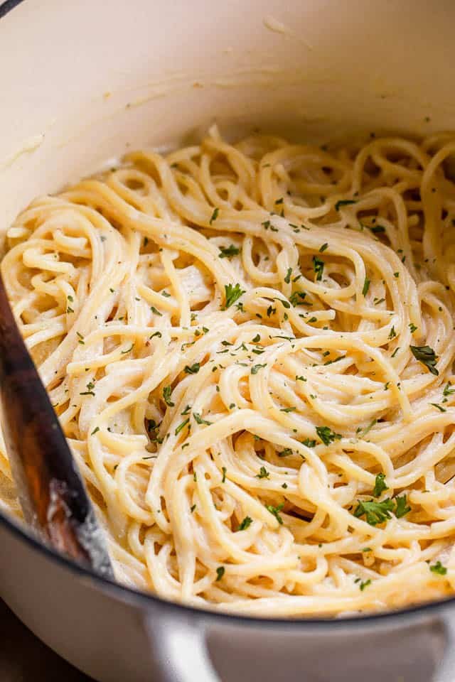 cooked spaghetti in a white dutch oven