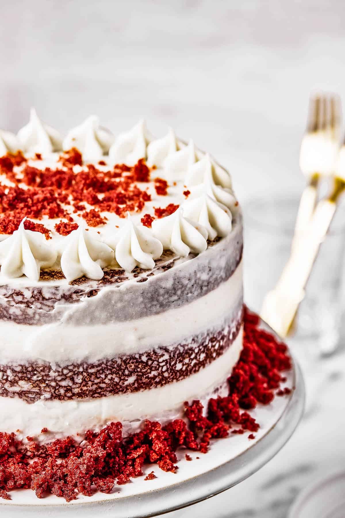 A frosted cake decorated with cake crumbs.