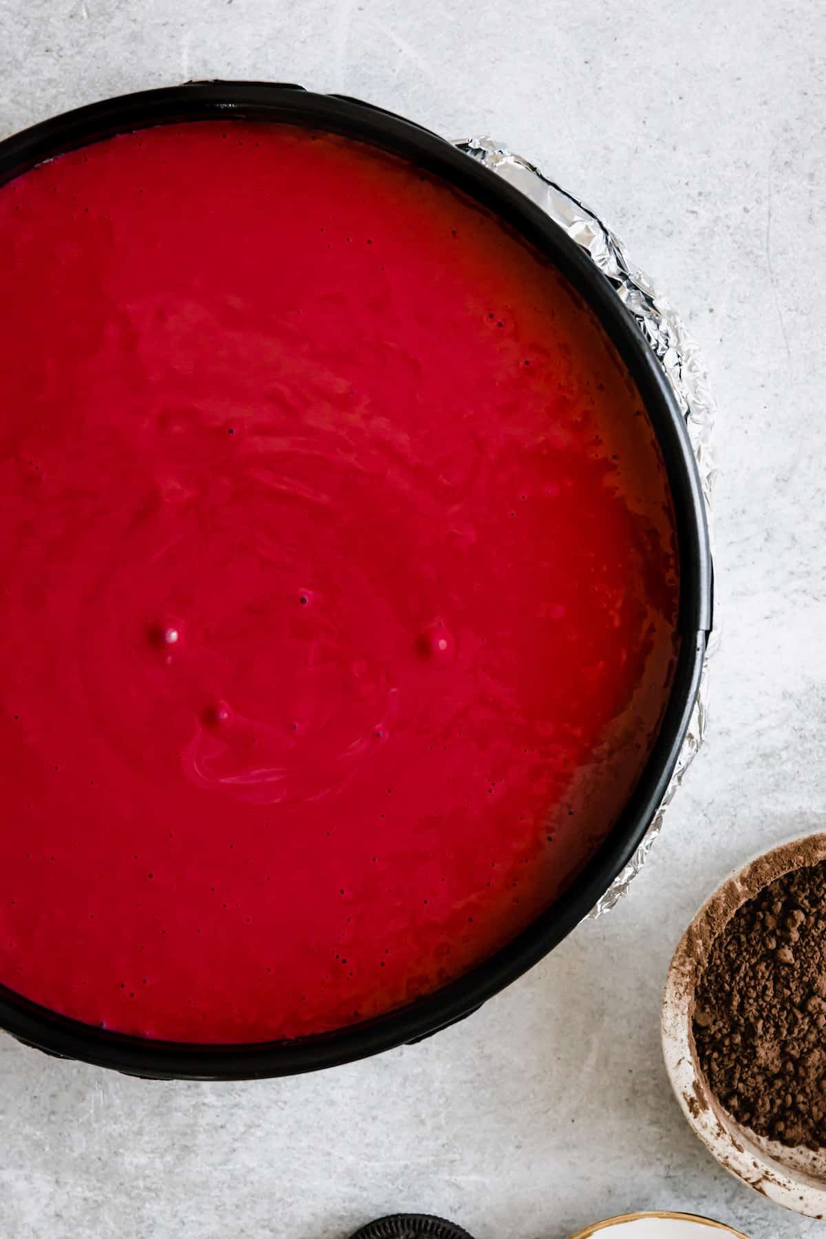 Bright Red Velvet Cheesecake Batter in a Springform Pan