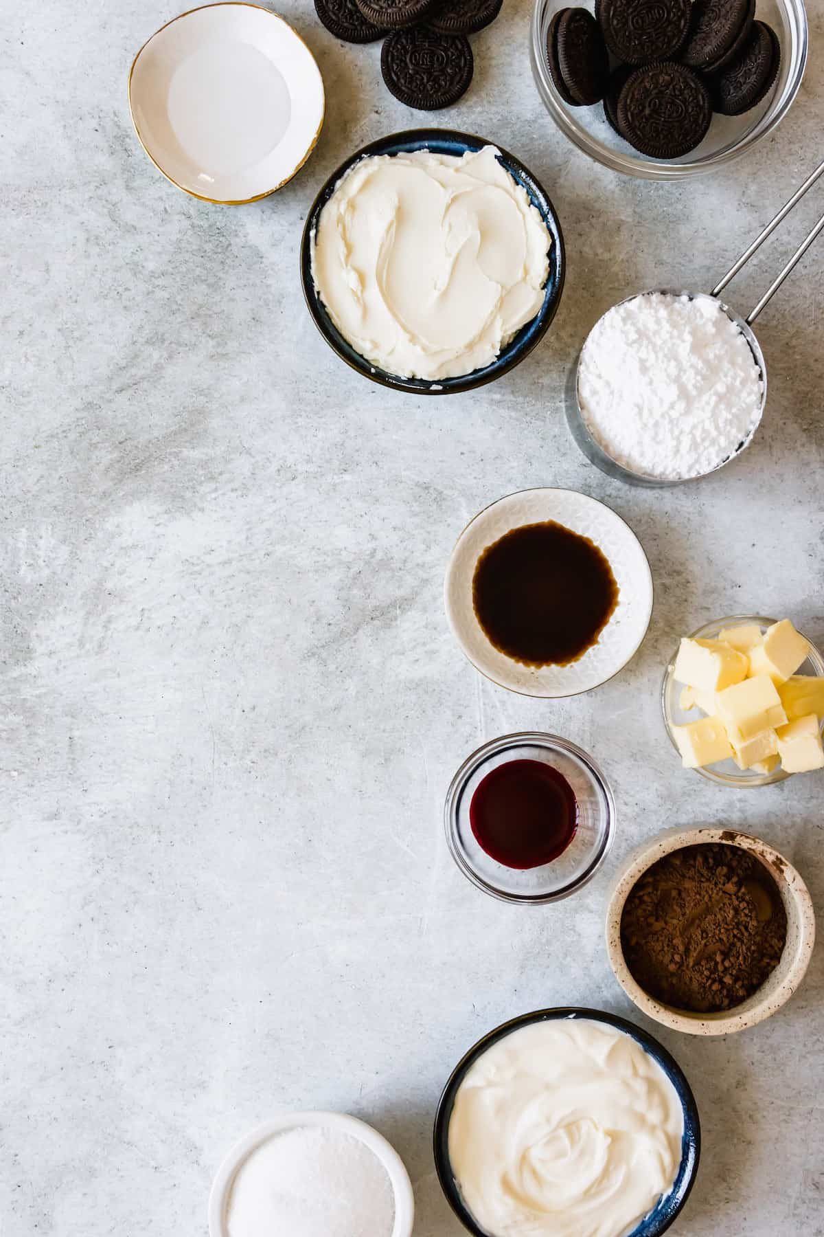 The Red Velvet Cheesecake Ingredients Assembled on a Light Gray Marble Counter