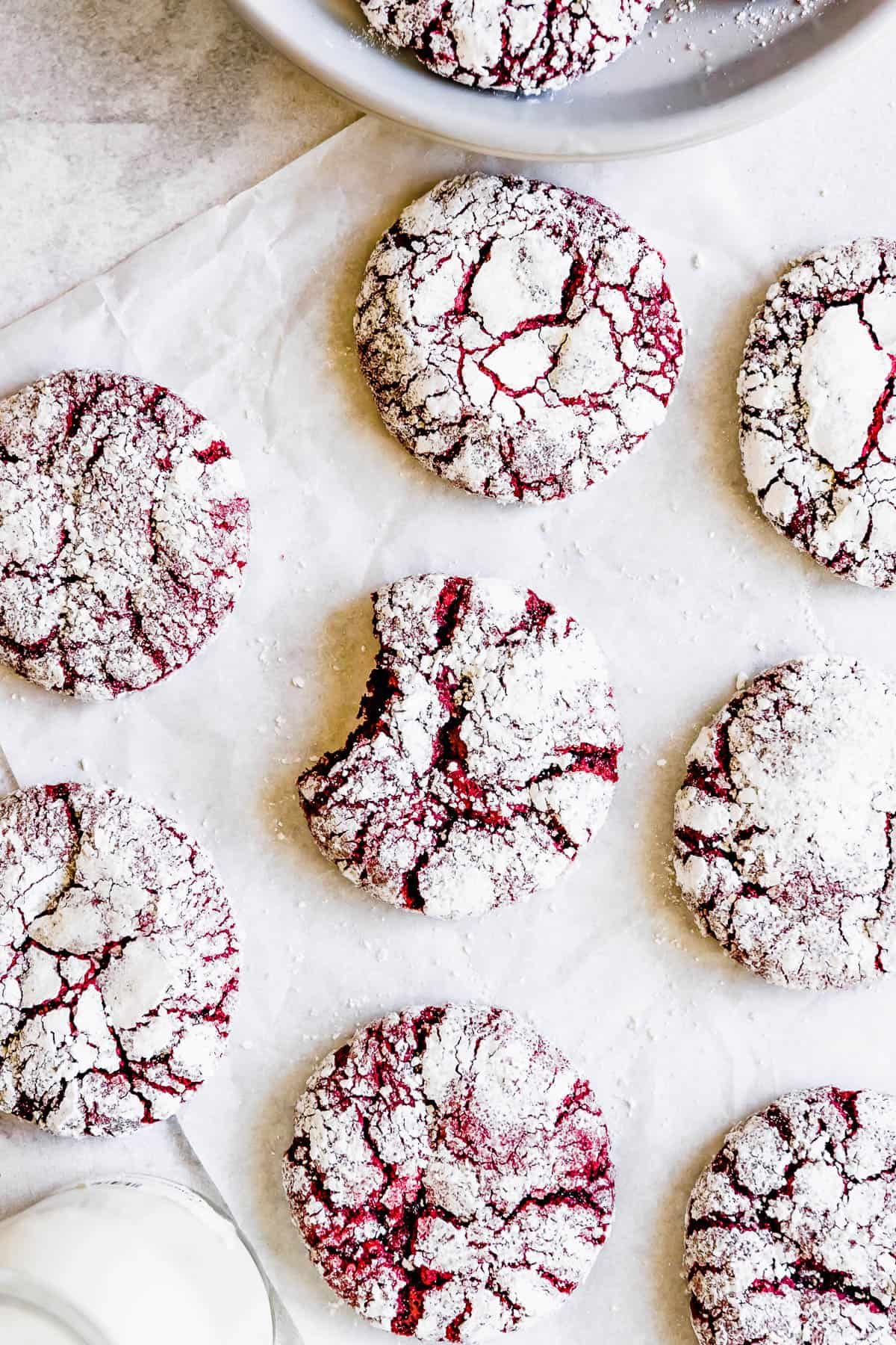Red Velvet Crinkle Cookies Arranged on a White Placemat, Seen From Above