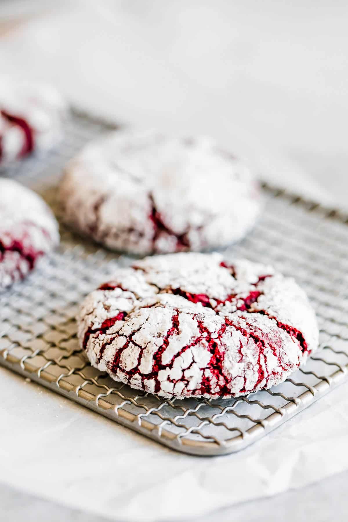 Four Red Velvet Cookies on Top of a Small Cooling Rack