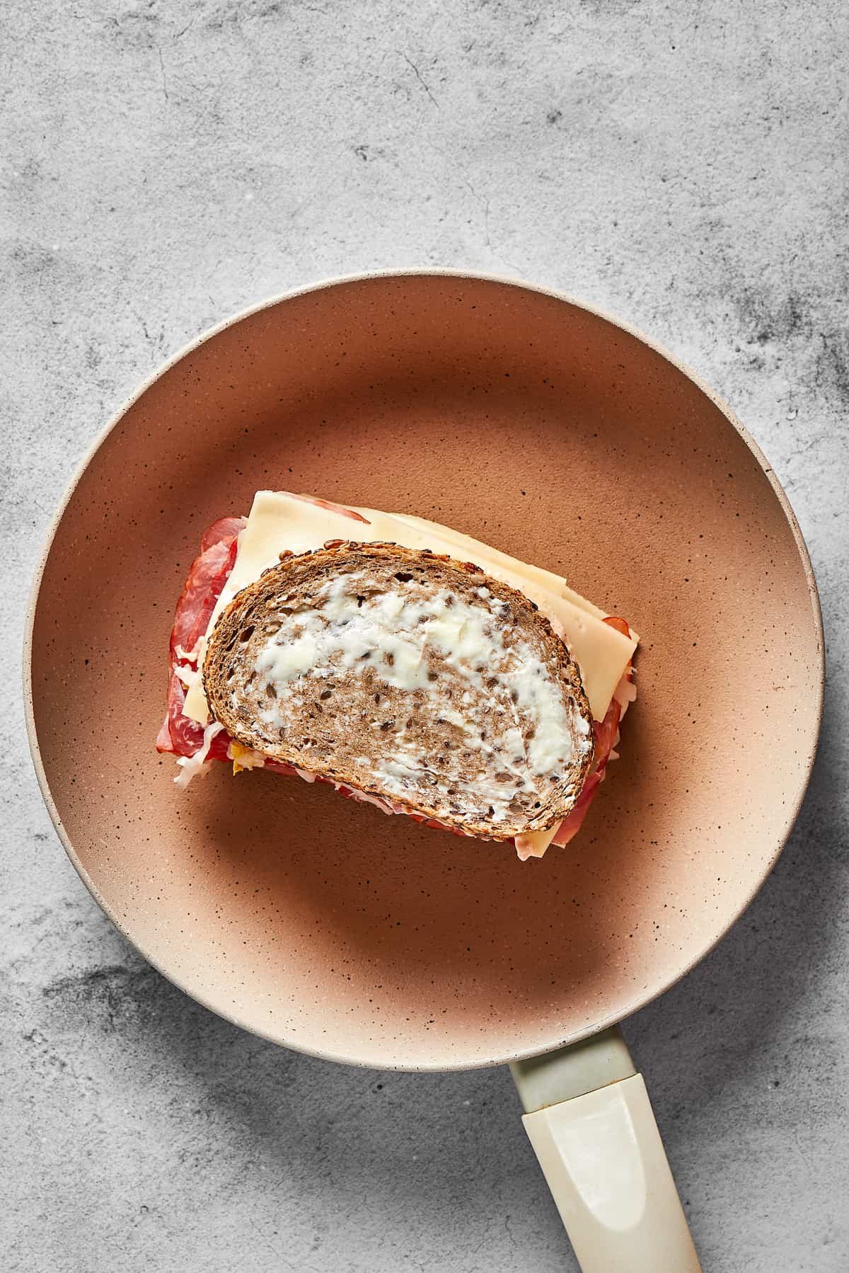 Grilling a Reuben sandwich in a skillet.