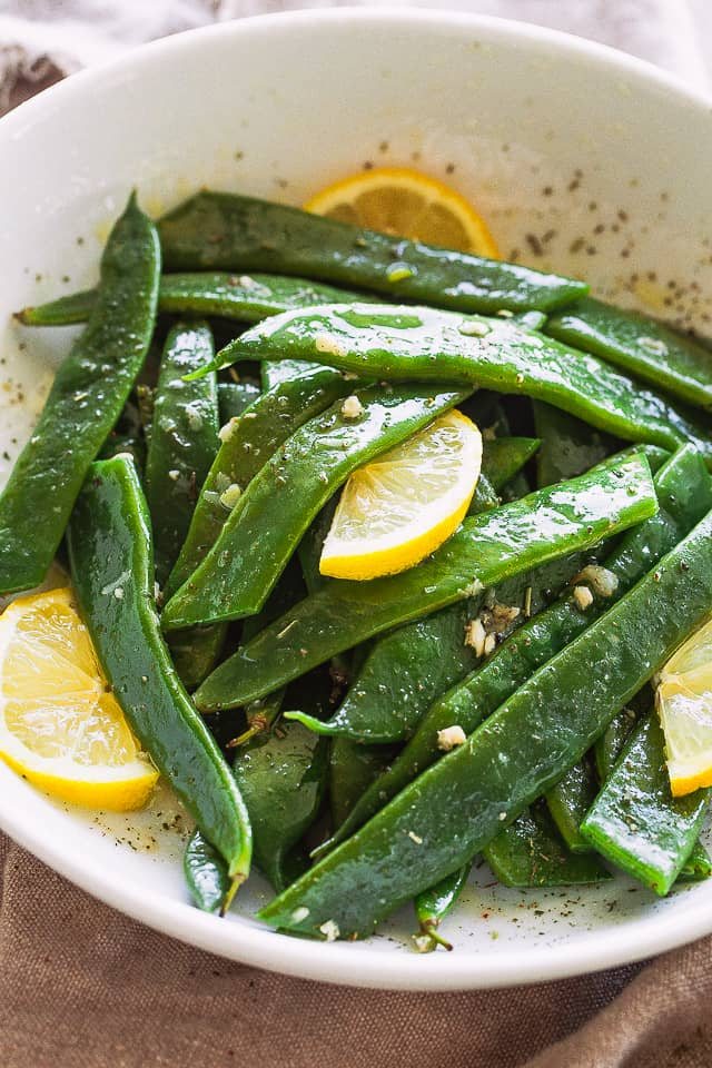 Garlic Butter Romano Beans served with lemon slices.