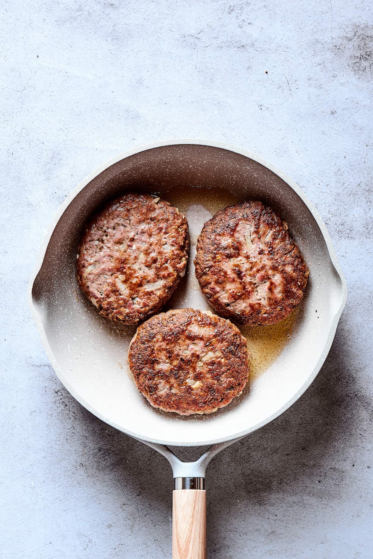 Browned patties in a skillet.