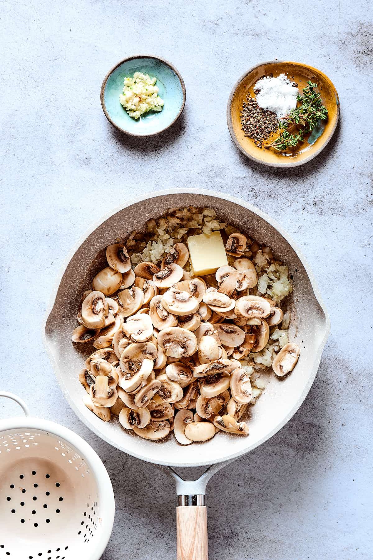 Mushrooms are added to the skillet.