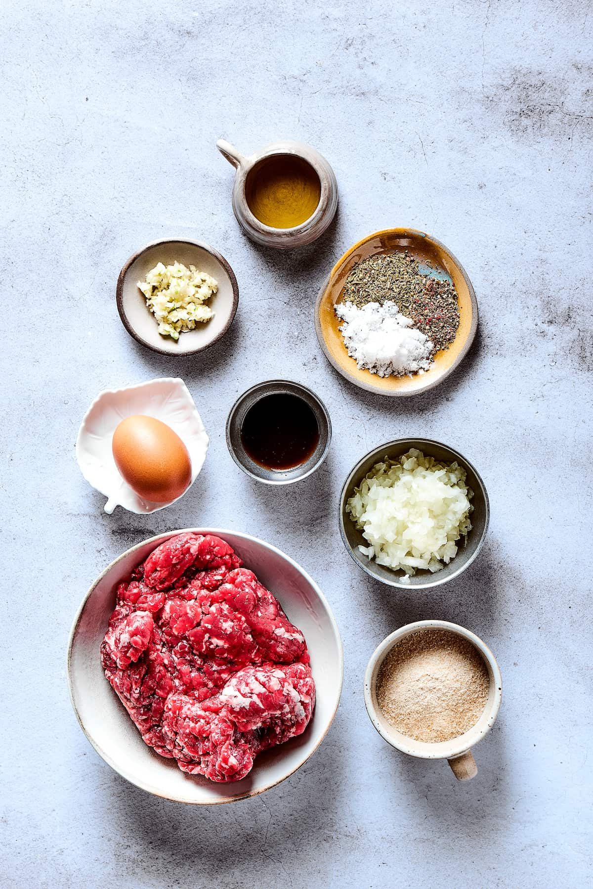 Salisbury steak ingredients measured and arranged on a work surface.