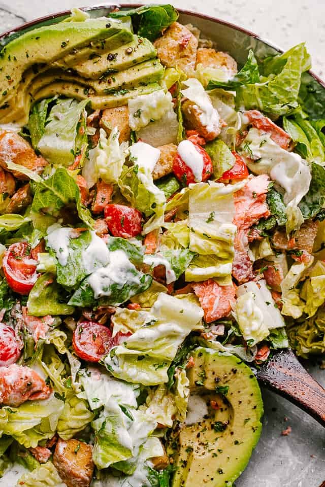Salmon BLT Salad plated and tossed in creamy dressing