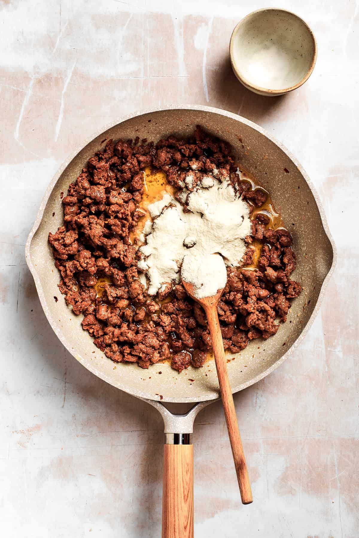 Flour is added into the pan.