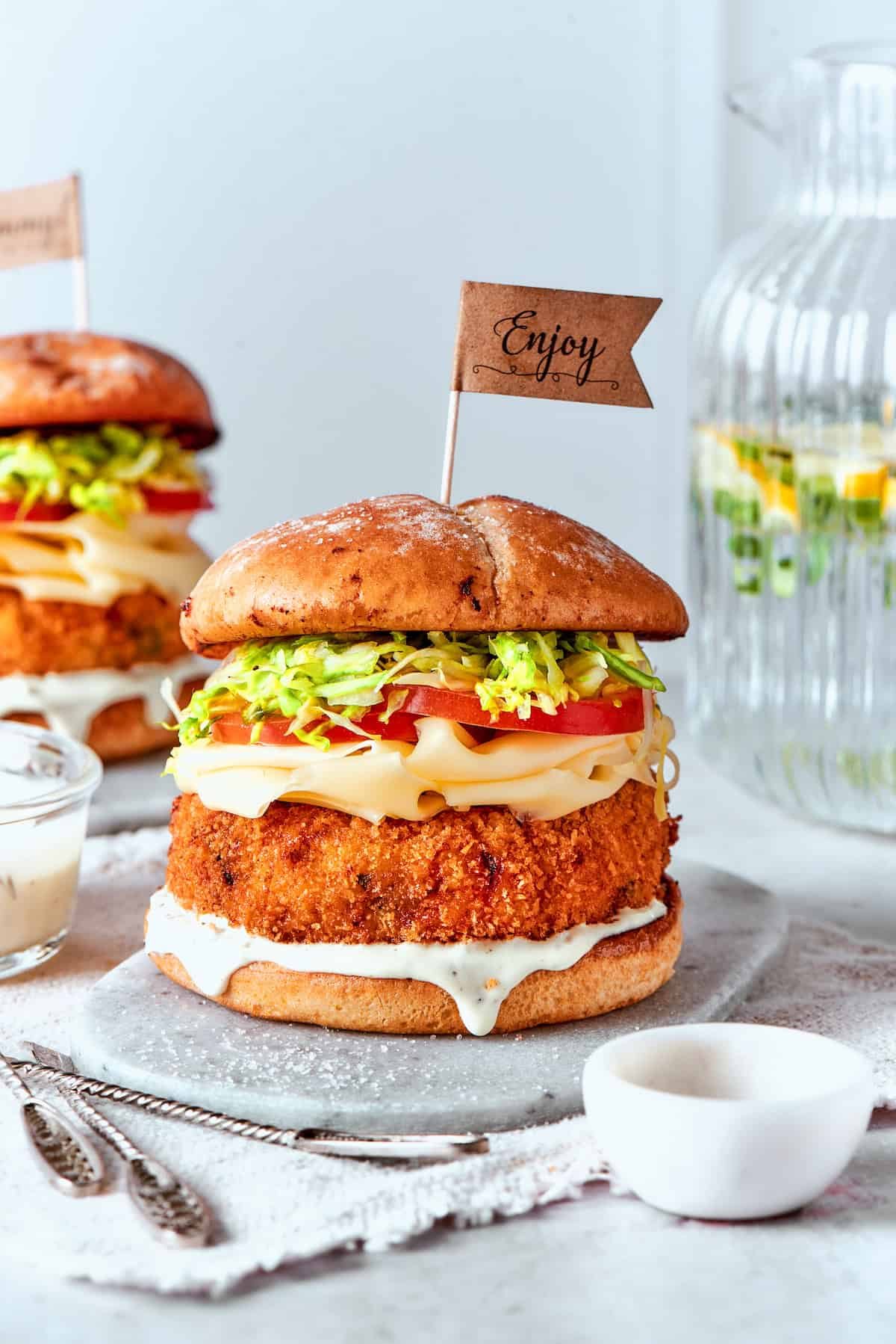Sauce is seen dripping from a shrimp burger.