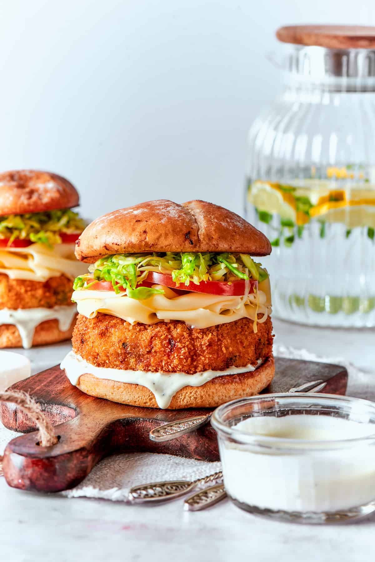 Shrimp burgers and sauce on a table.