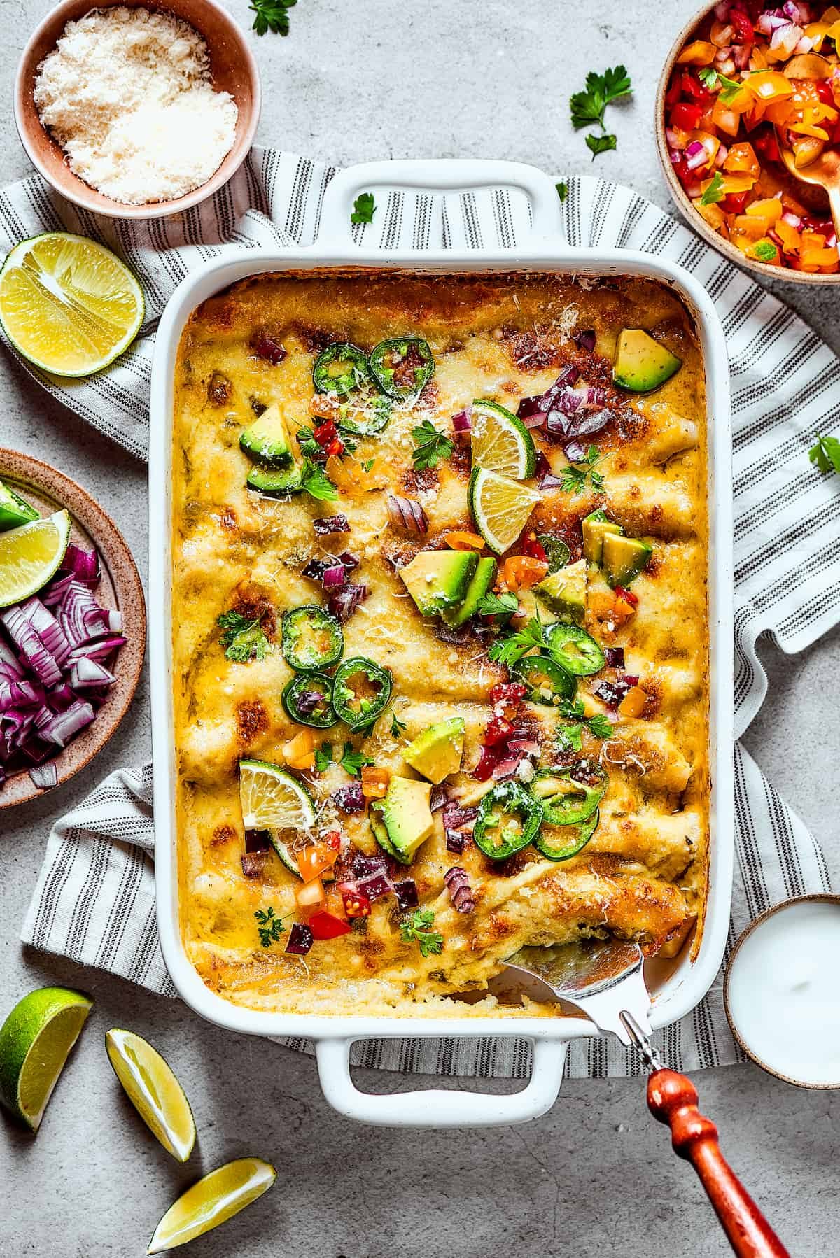 Baked shrimp enchiladas with toppings.