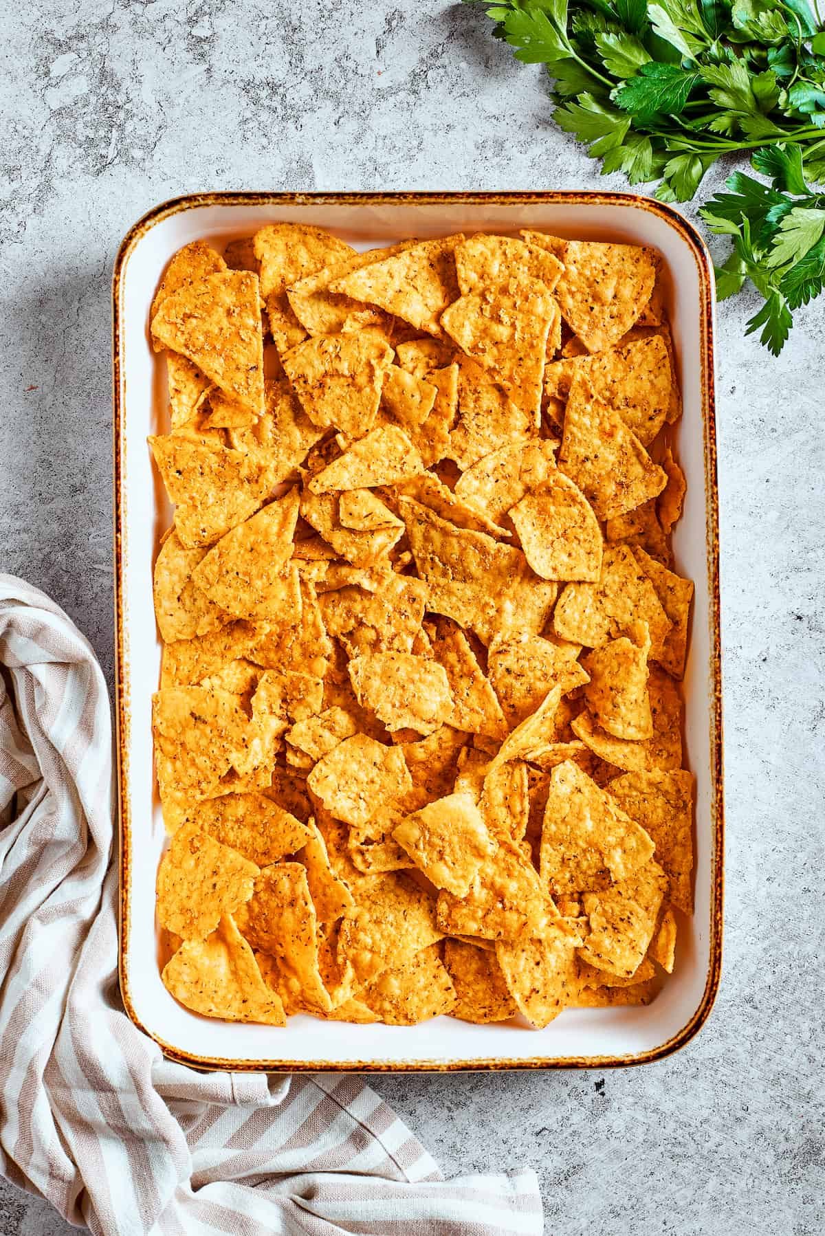 Nachos are arranged in a baking tray.