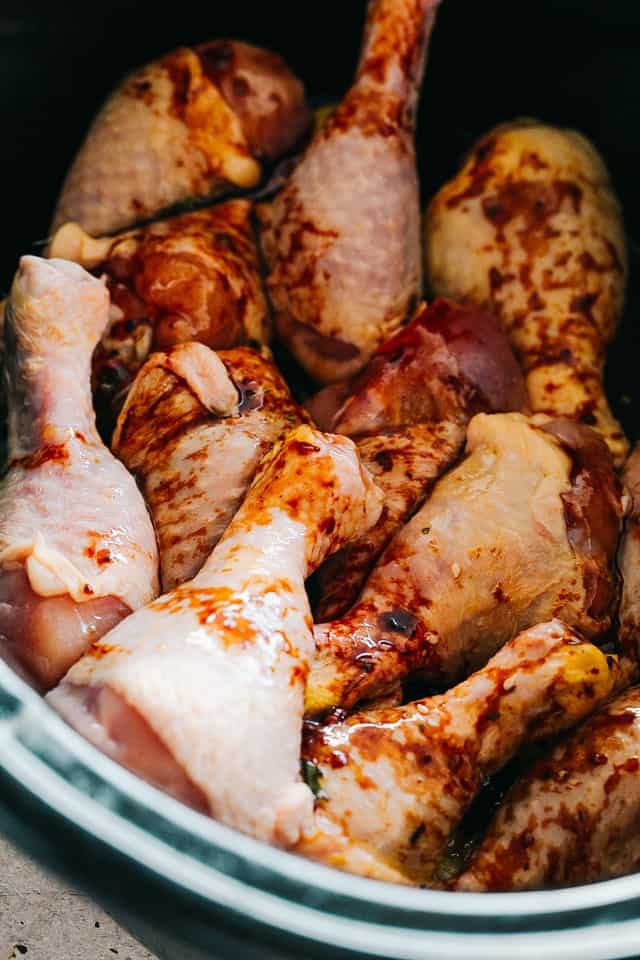 raw chicken legs in a slow cooker