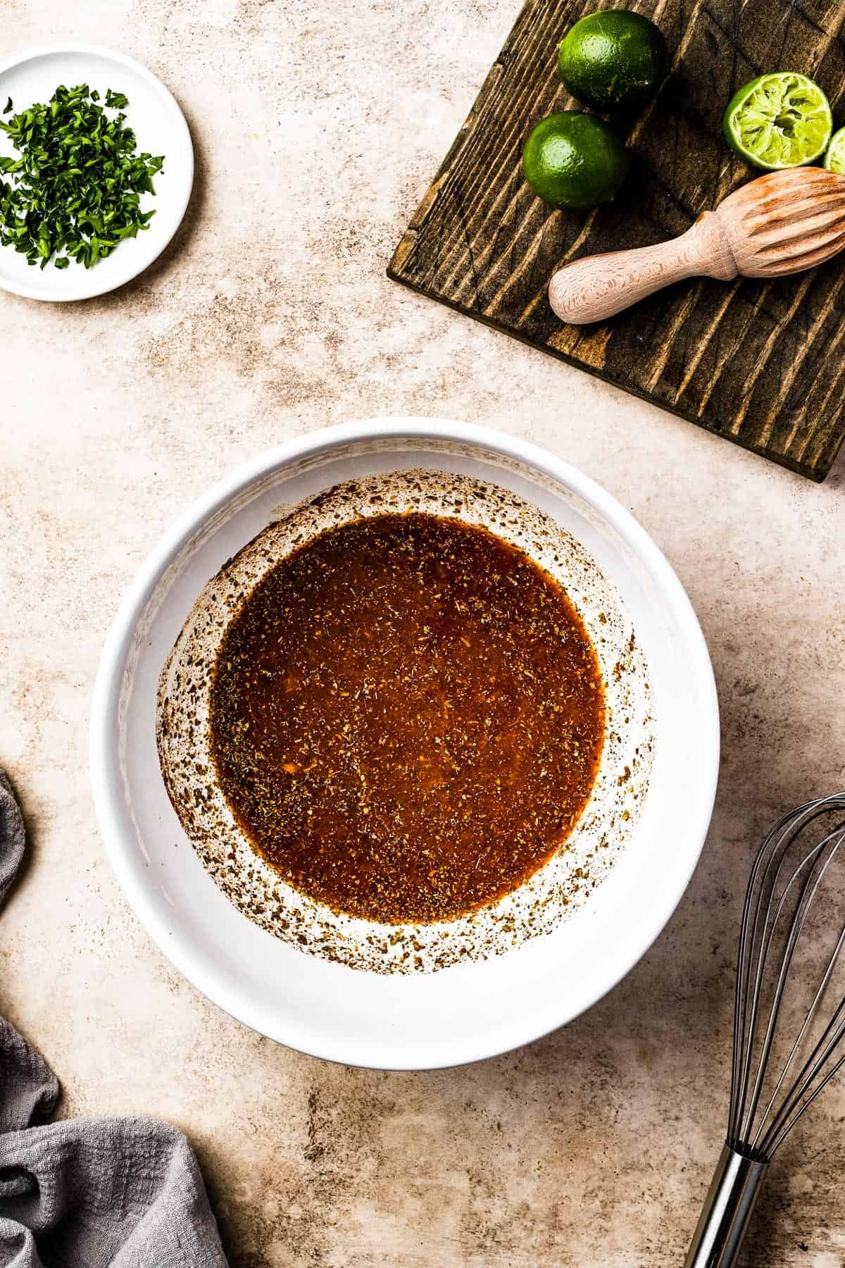 A citrus and spice mixture in a white bowl.
