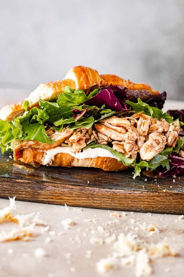 side view of shredded bbq chicken croissant sandwich