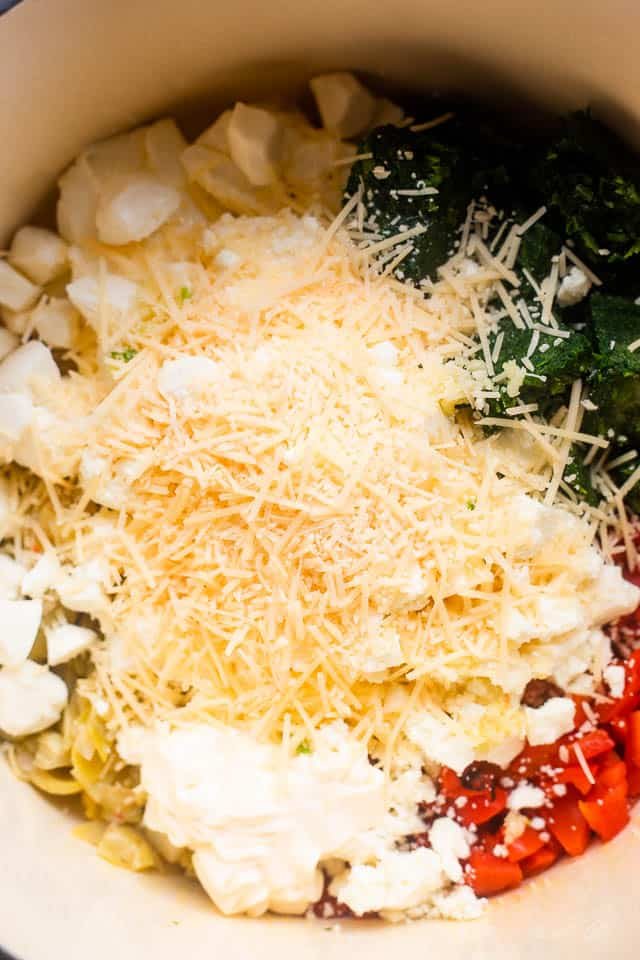 overhead shot of ingredients for spinach artichoke dip in slow cooker