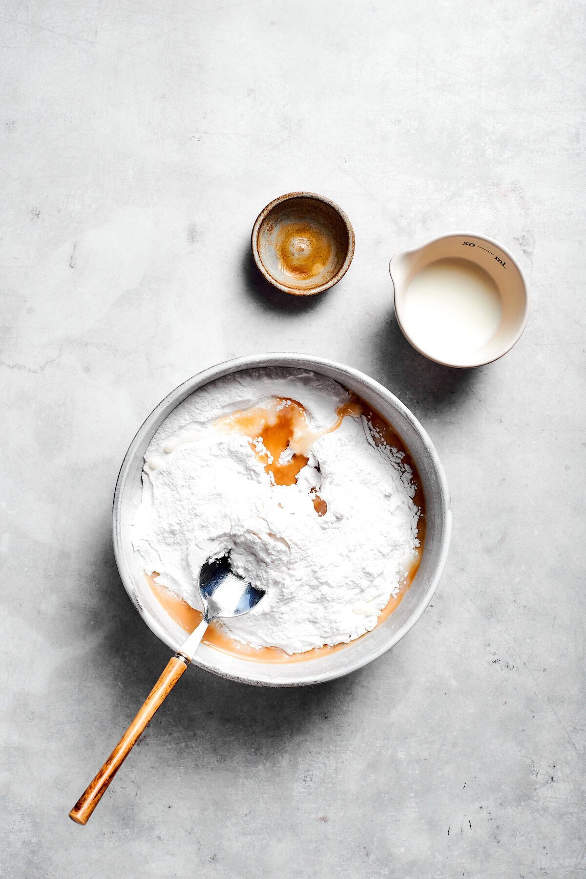Icing is mixed in a bowl.