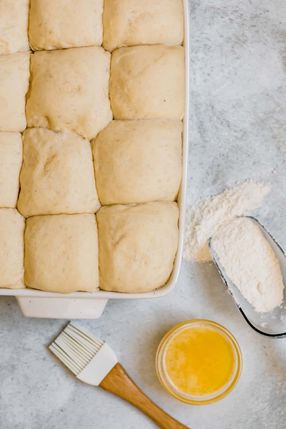 The Risen Dinner Roll Dough Balls Packed Together in the Baking Pan
