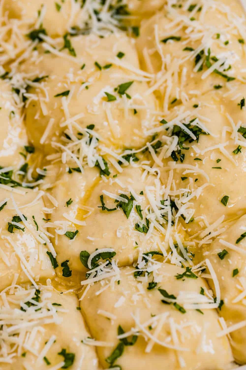 A Close-Up Shot of Cheesy Dinner Roll Dough Balls Seasoned with Parsley