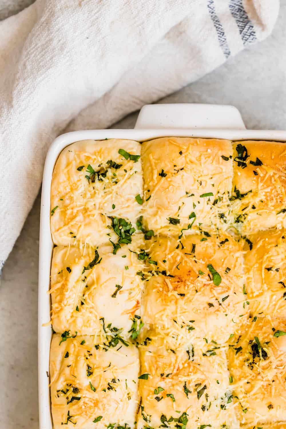 A Pan Full of Baked Dinner Rolls With Parmesan & Parsley