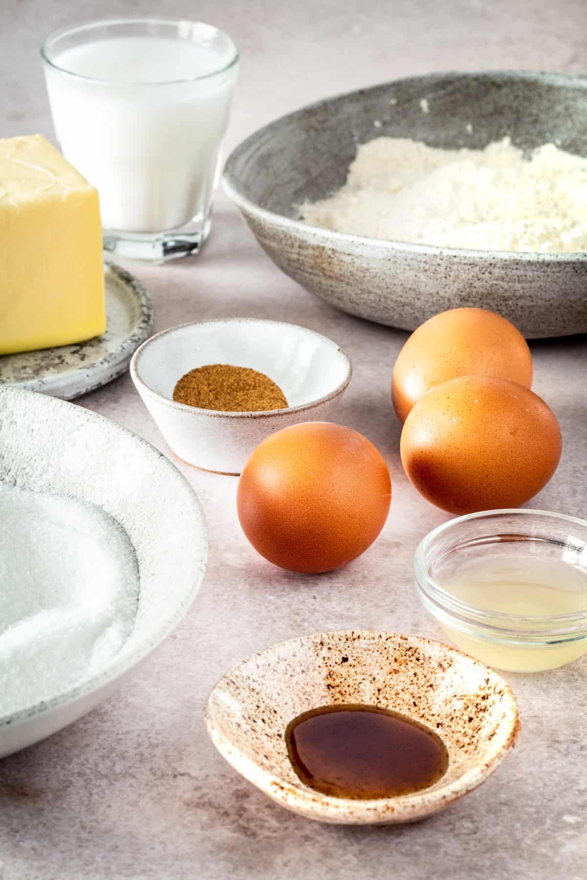 Clockwise from top left: Butter, buttermilk, nutmeg, eggs, flour, lemon juice, vanilla, sugar.