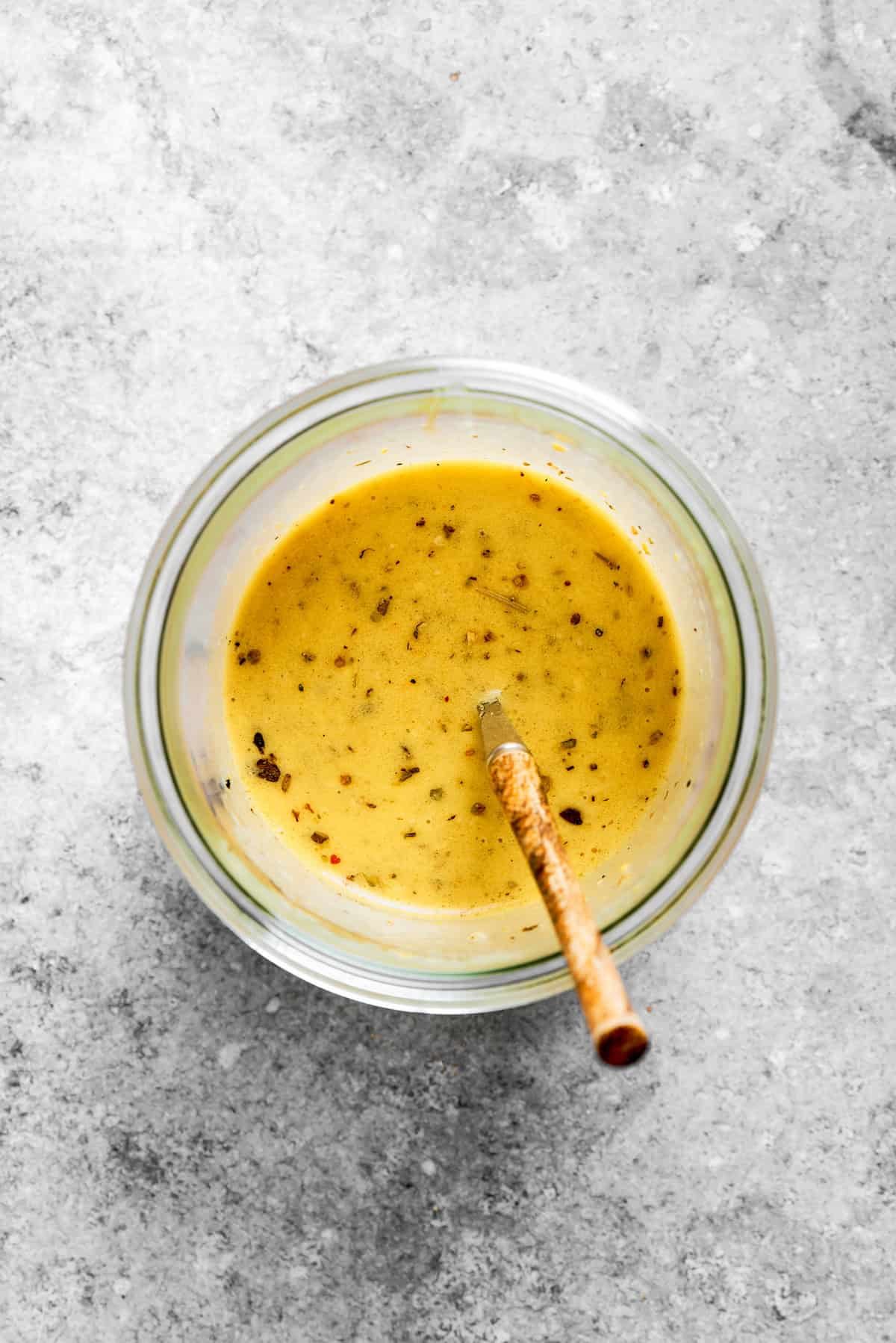 The dressing is mixed in a bowl.
