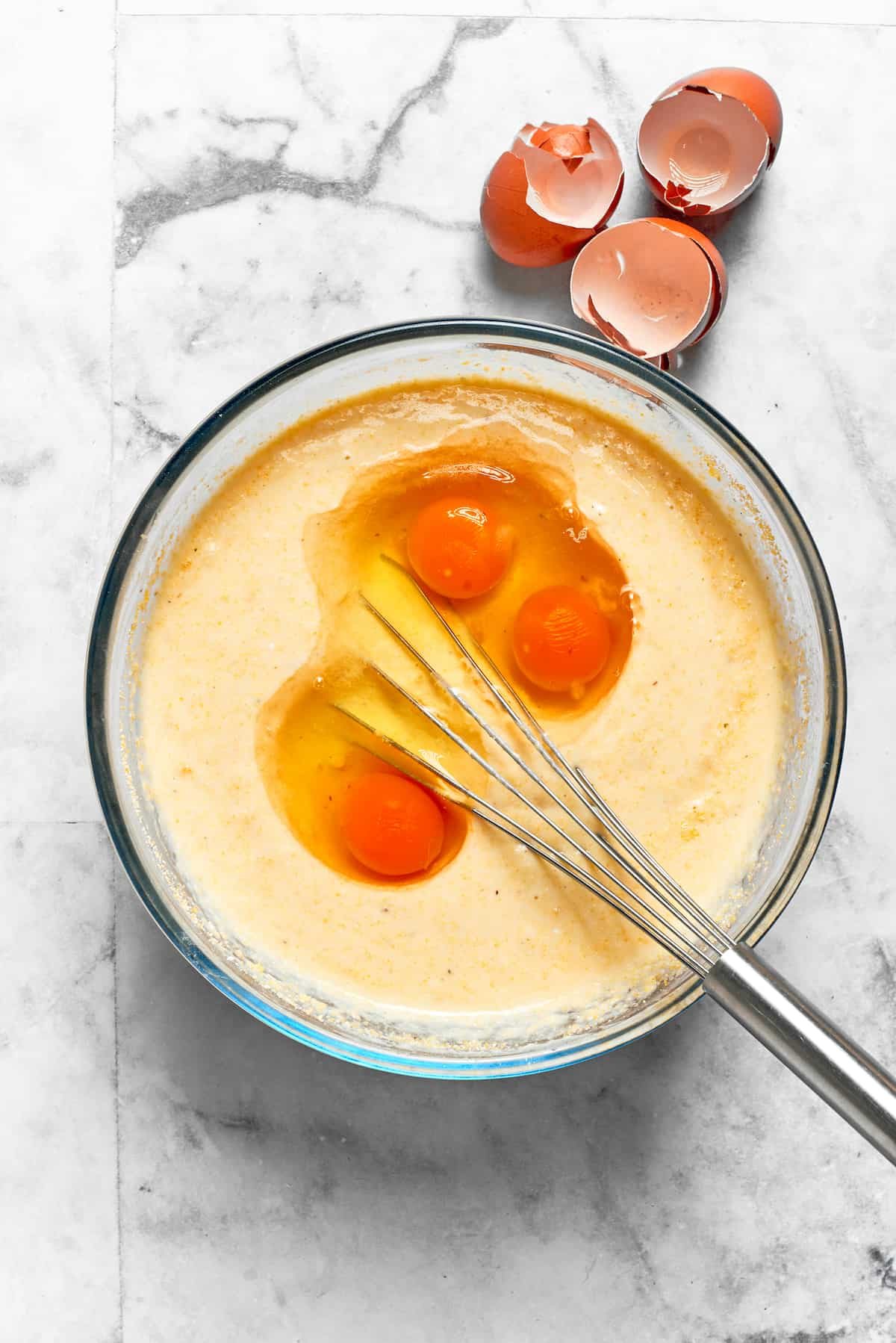 Eggs are whisked into the batter.
