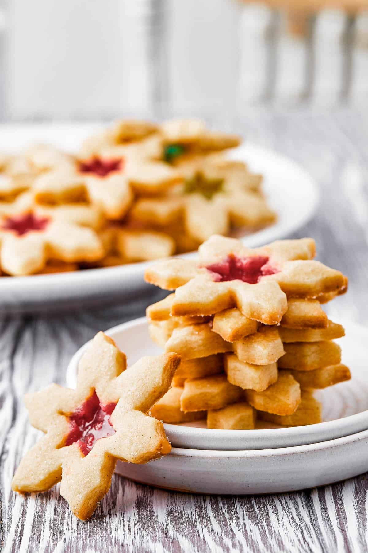 A platter of cookies, with five cookies stacked on a small plate nearby. One cookie is offset, leaning against the small plate.