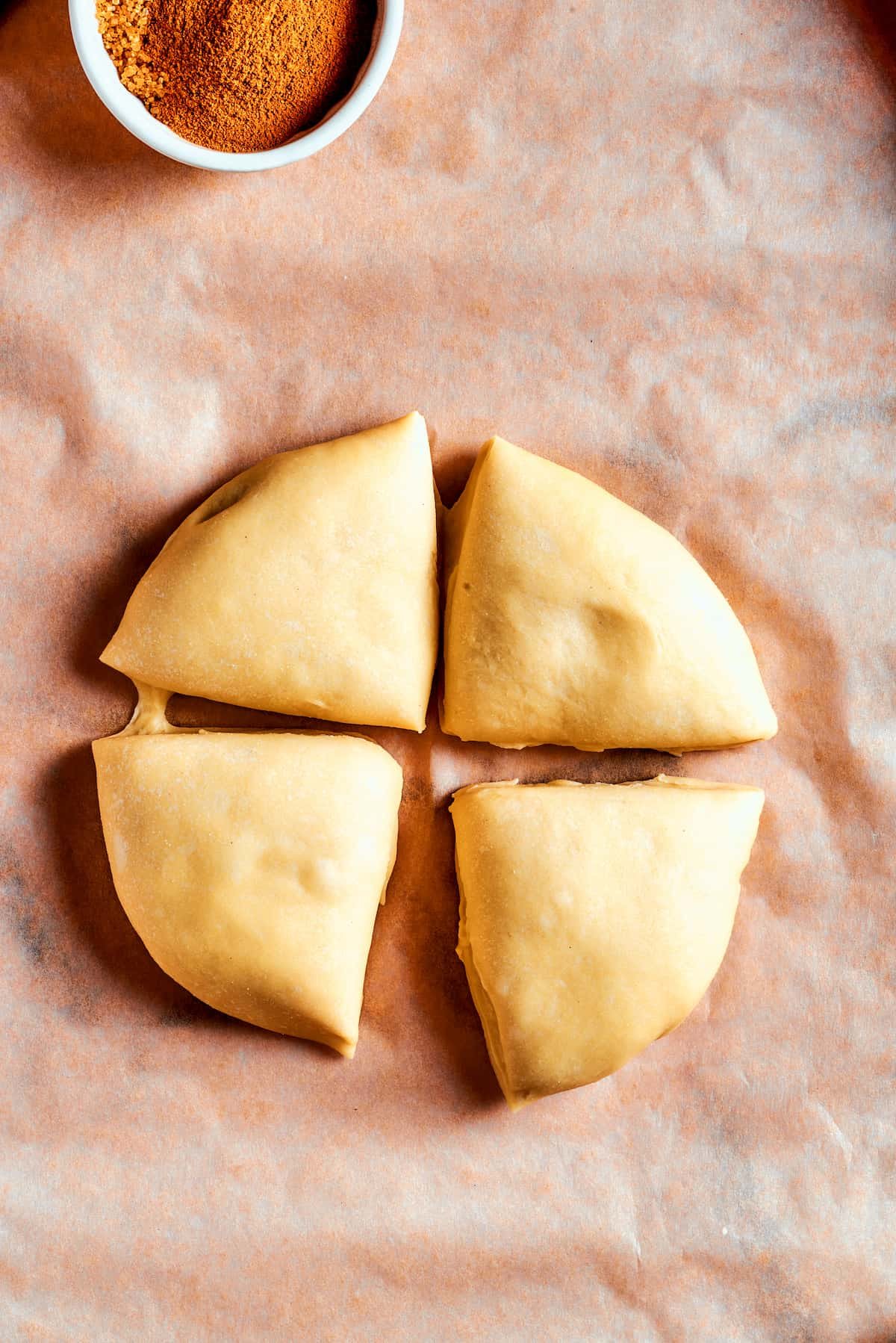 Overhead view of dough cut into 4 segments.