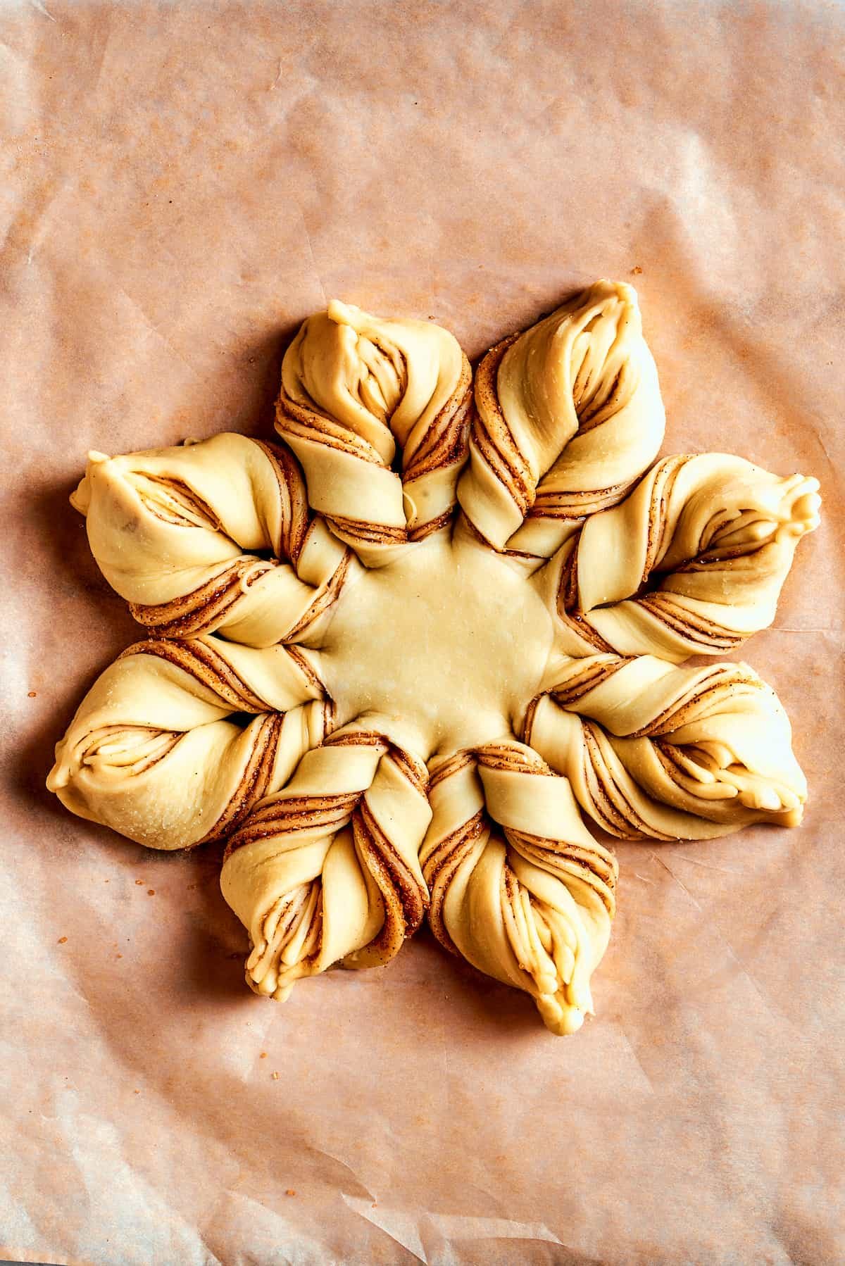 Overhead view of a fully assembled star bread before being baked.