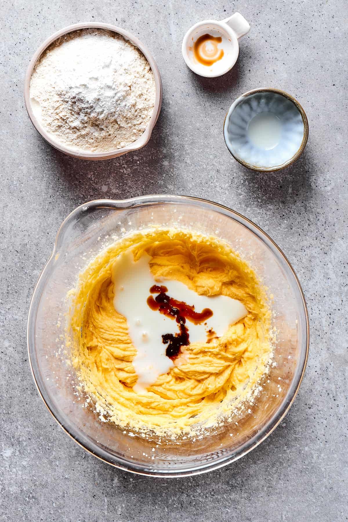 Vanilla and milk added to wet cupcake batter ingredients.