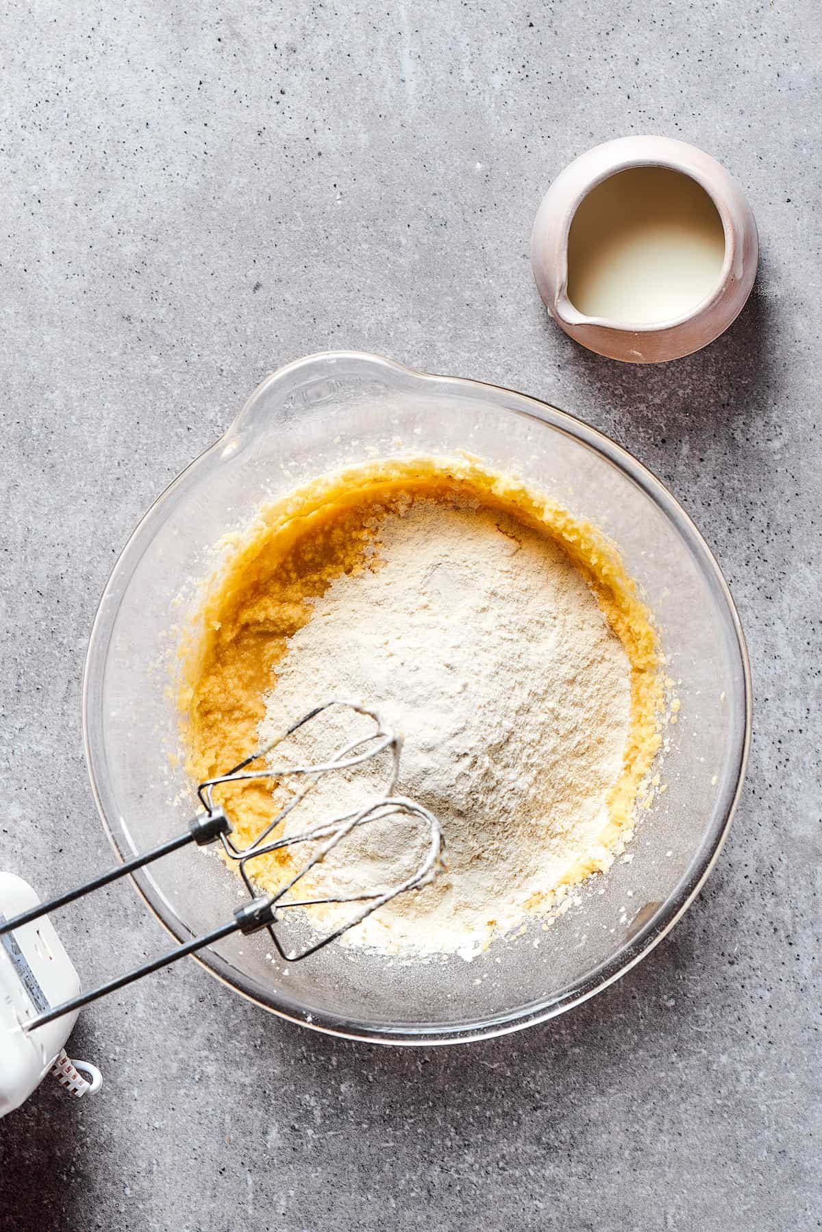 Mixing dry and wet ingredients in a mixing bowl.