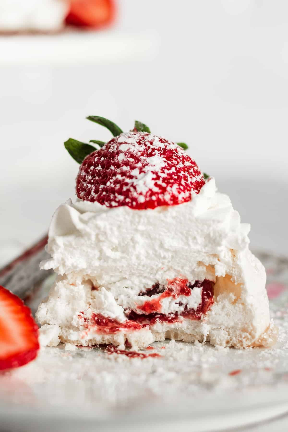 The inside of a pavlova with strawberry jam