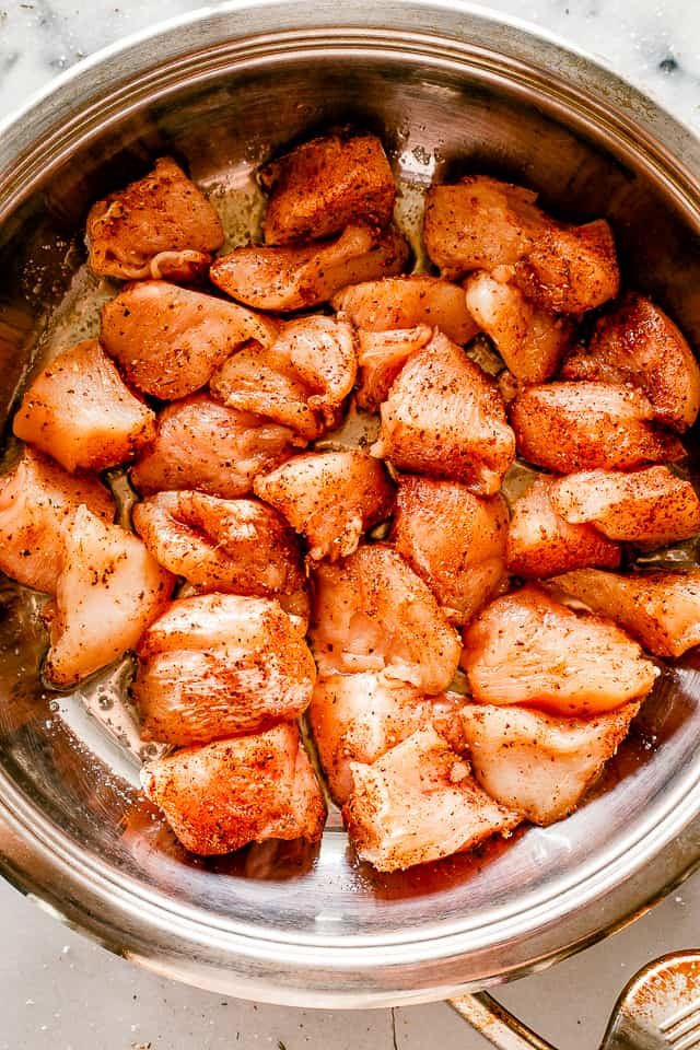 Cooking chicken bites in a skillet.