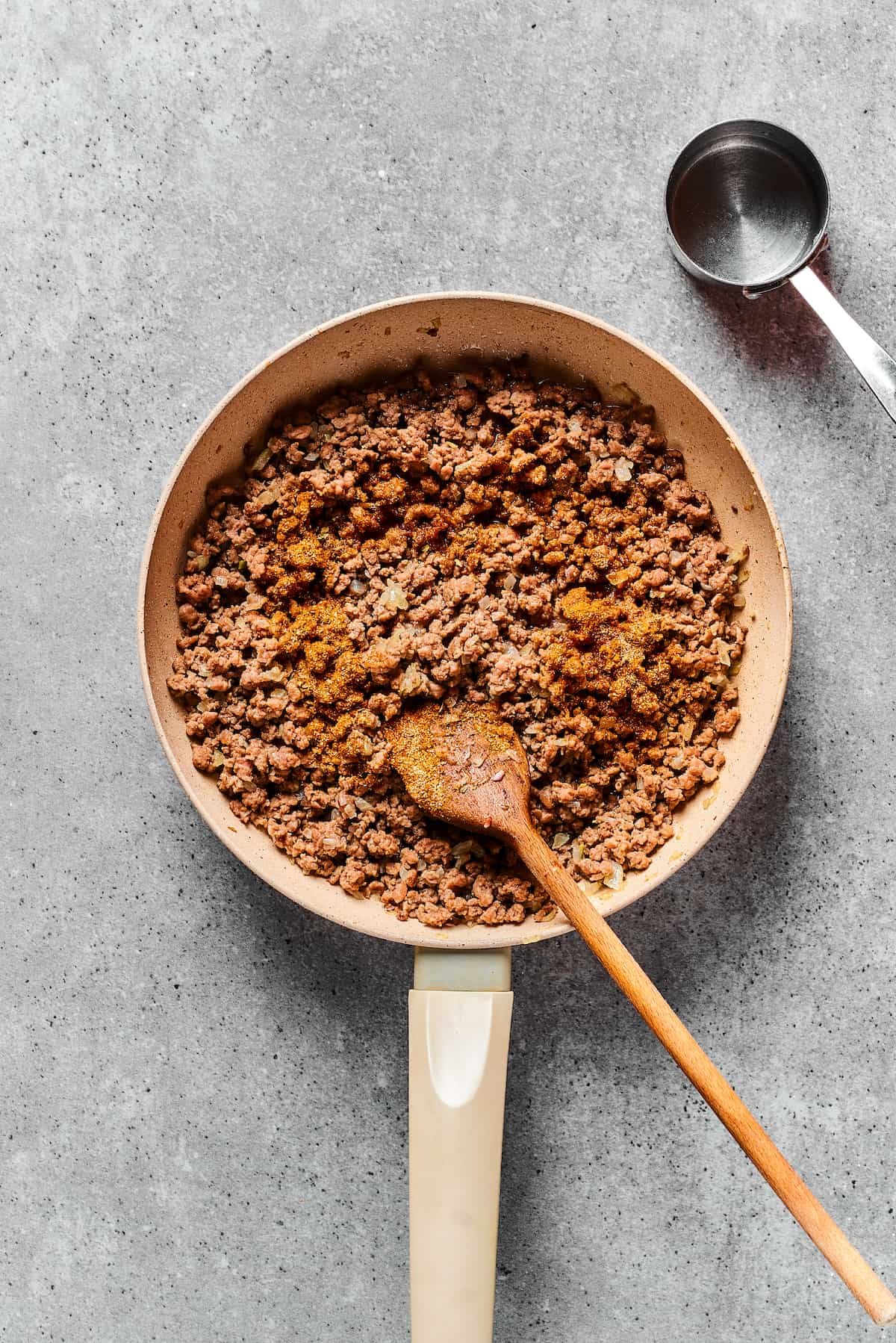 Taco meat cooked in a skillet.