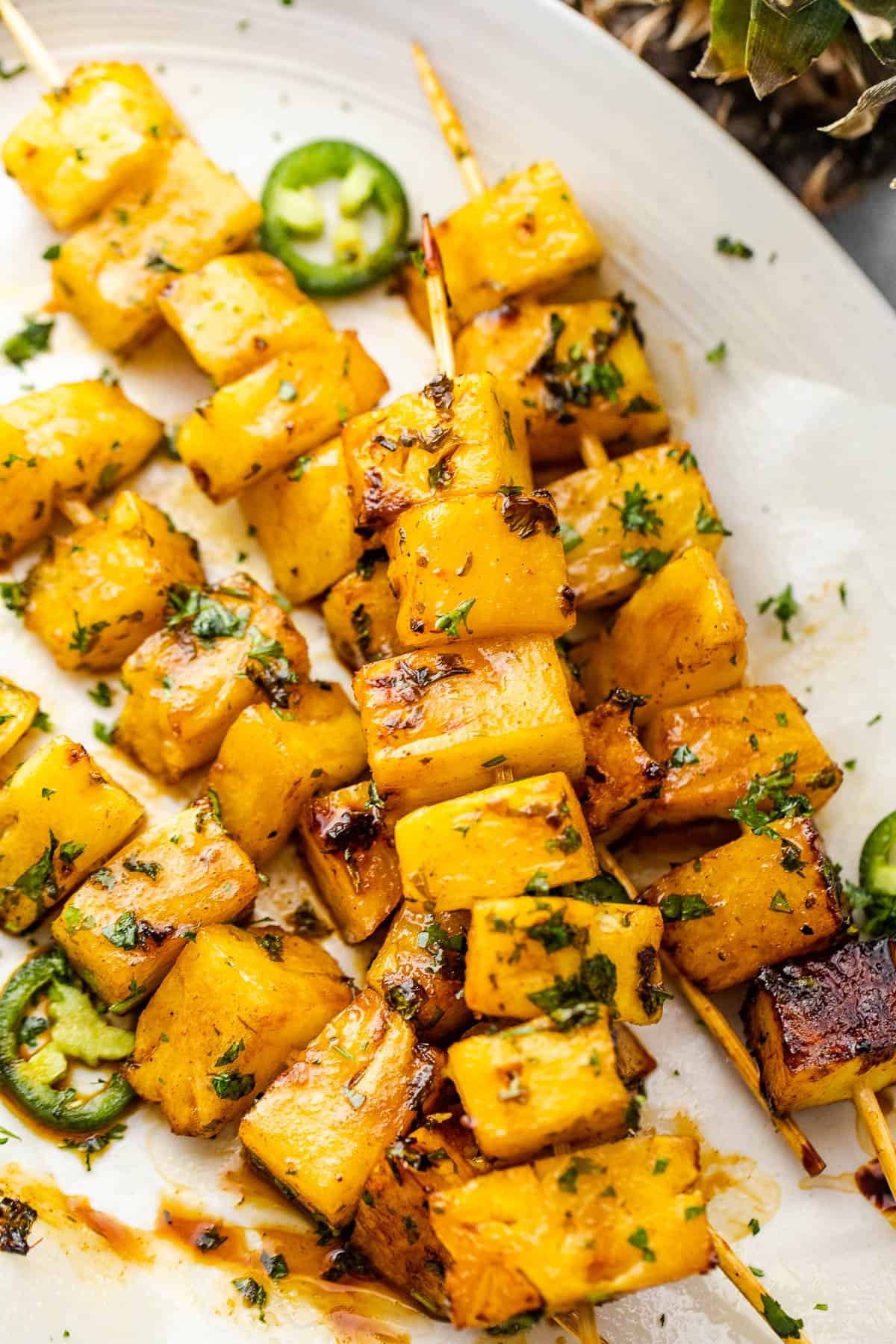 grilled tequila pineapple skewers served on a plate