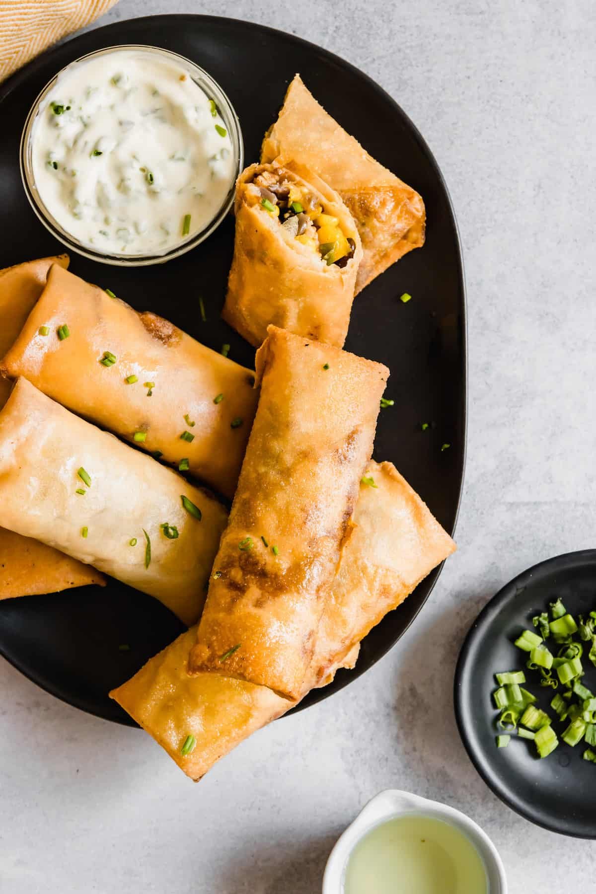 A Platter of Homemade Egg Rolls on a Gray Countertop