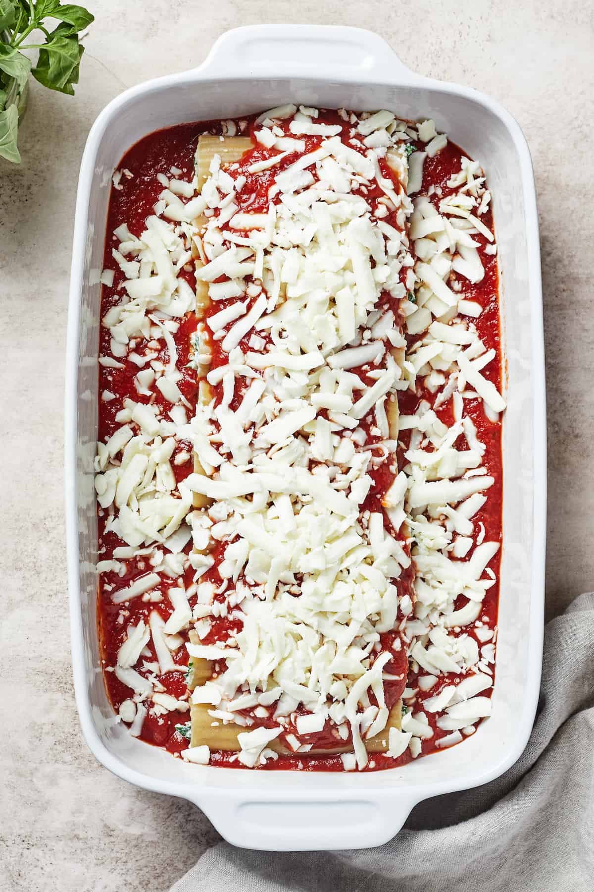 A pasta casserole sprinkled with cheese.