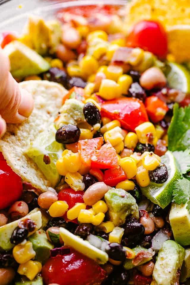 scooping up Cowboy Caviar with a tortilla chip