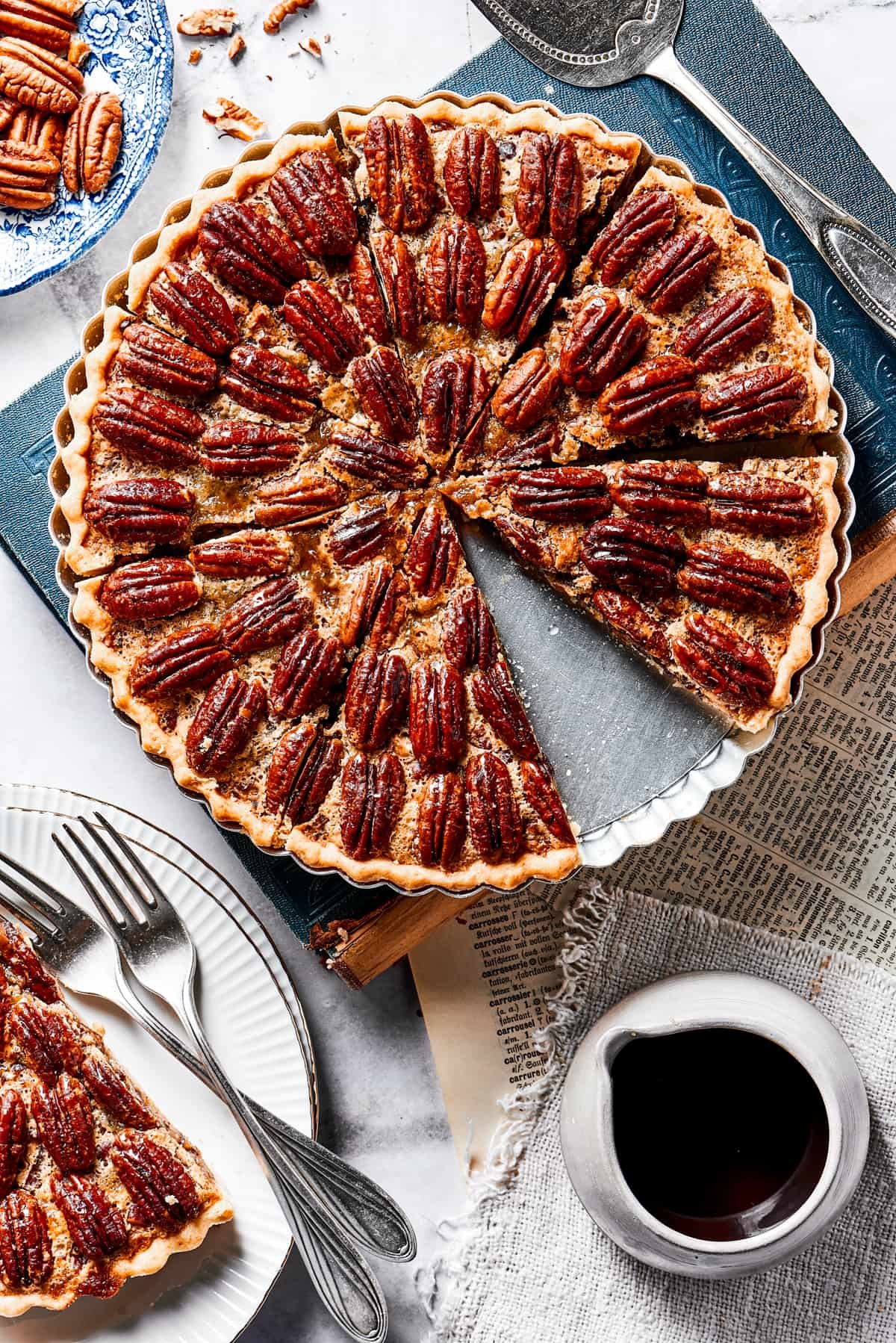 A slice of pie on a small serving dish, next to the larger pie.