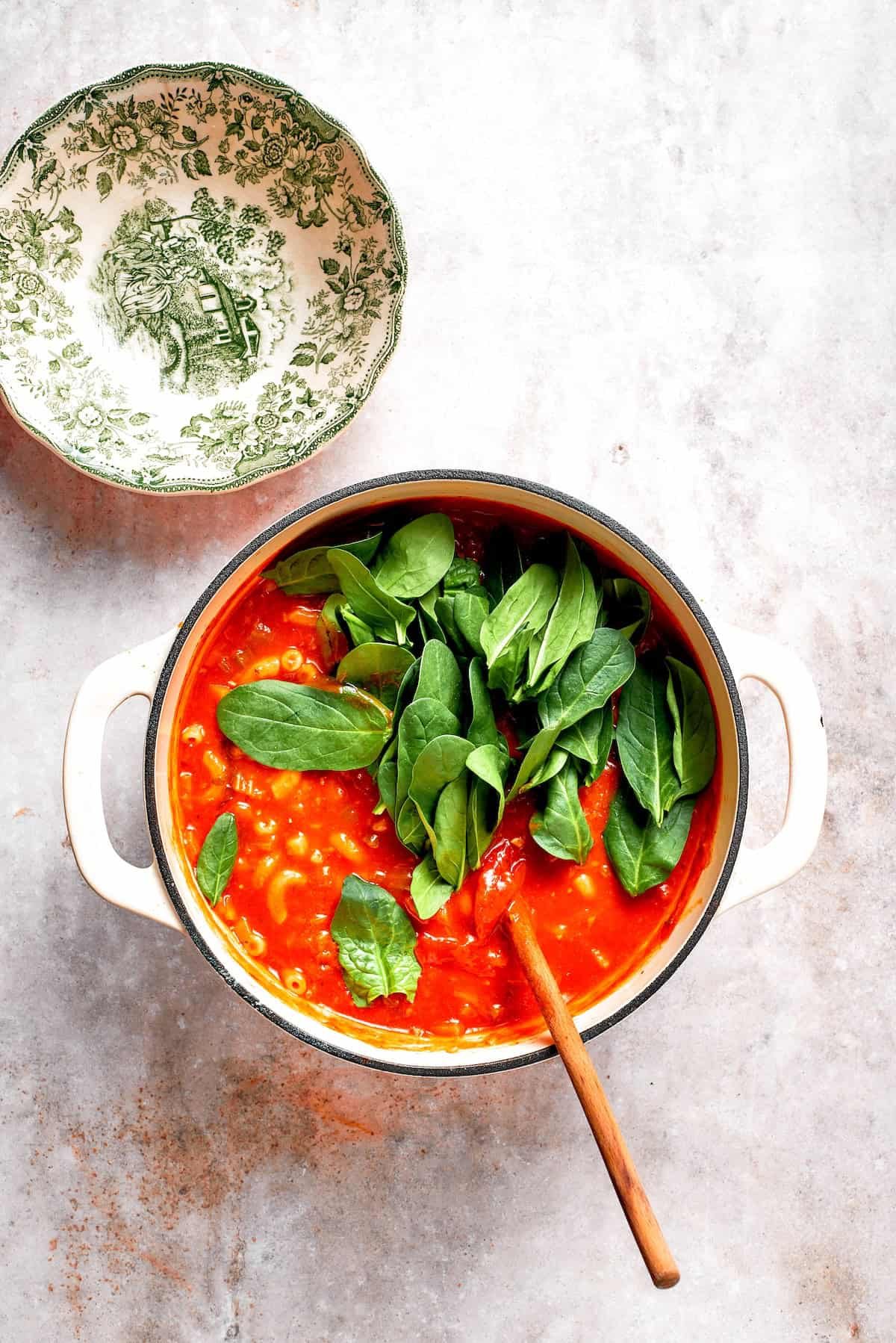 Spinach is stirred into tomato florentine soup.