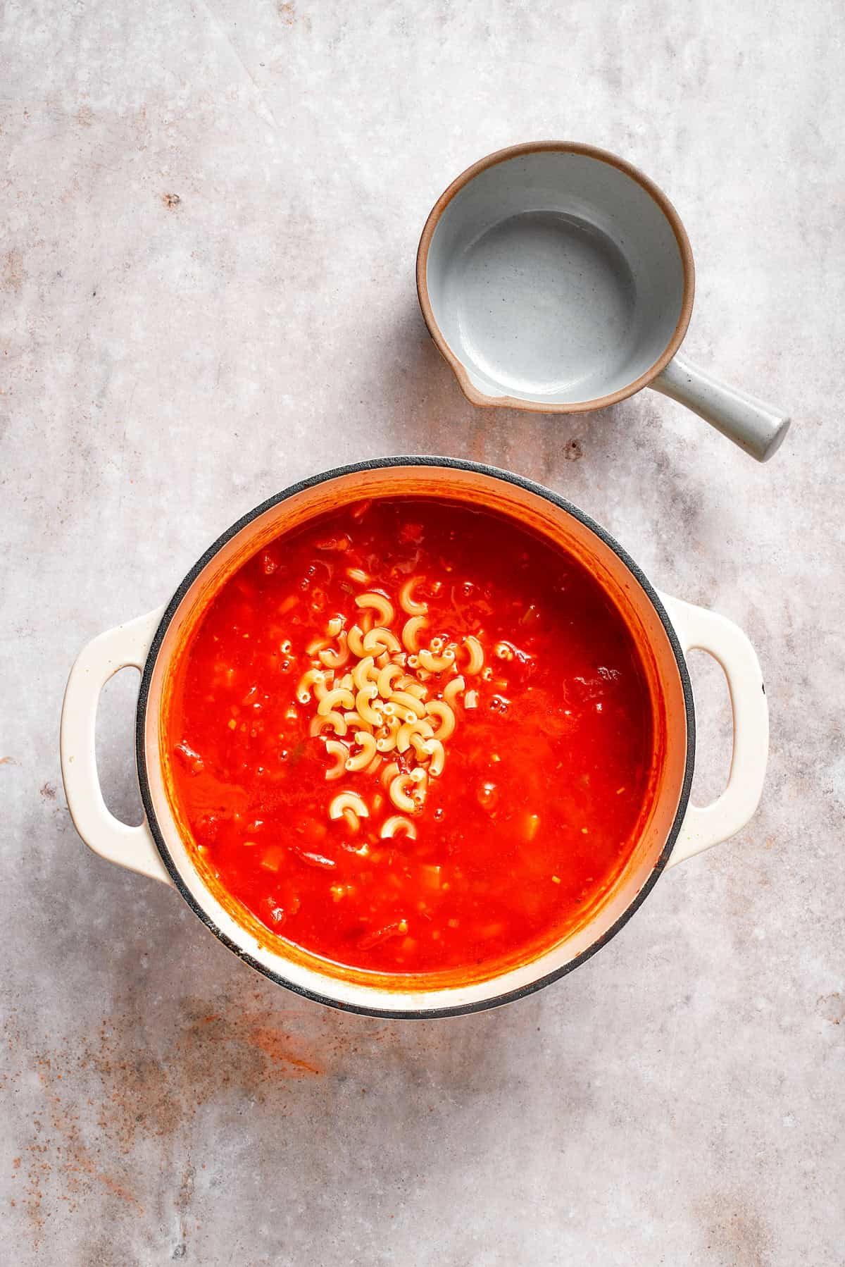 Pasta is added to tomato florentine soup.