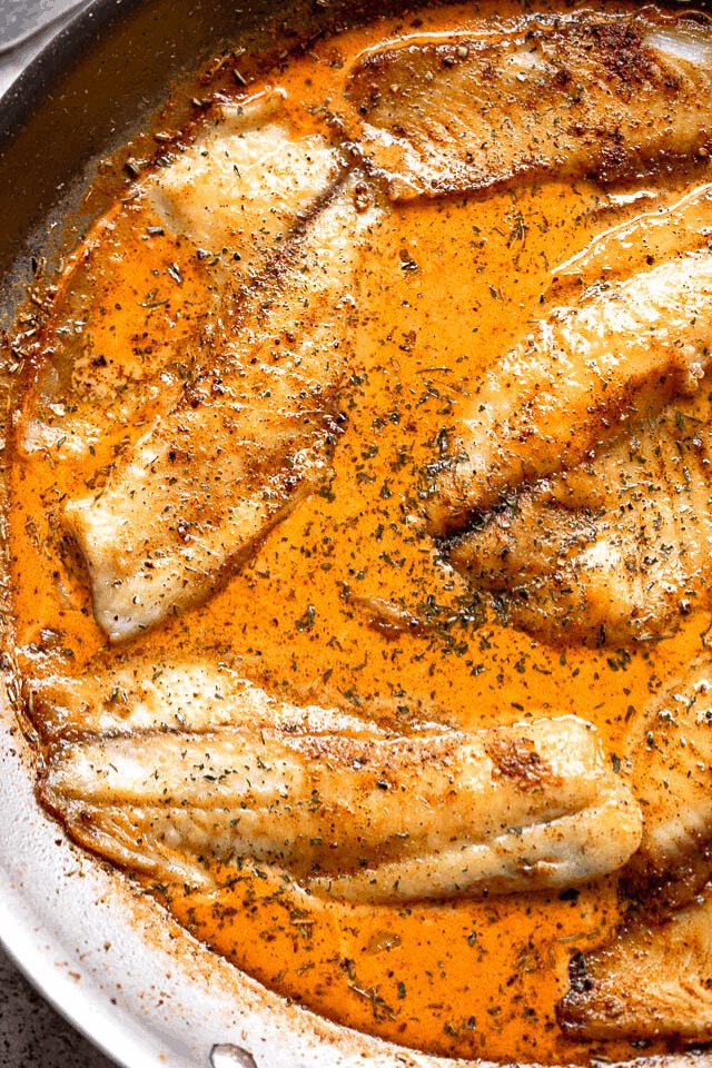 cooking tilapia fillets in a creamy tomato sauce