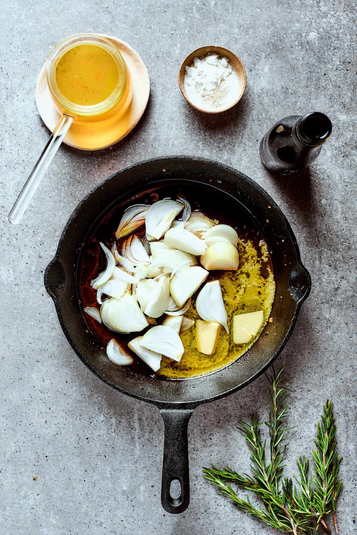 Cooking onions in melted butter in a skillet.